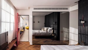 A bedroom with a bed, wardrobe, and a view into an adjacent room. - Hayarkon 70 - Boutique Aparthotel (Tel Aviv)