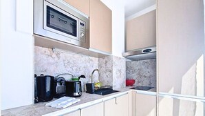 A compact kitchen with a microwave, toaster, sink, and cabinets. - N&J - STUDIO ANNA - Central Nice • AC • Walk to beach (Nice)