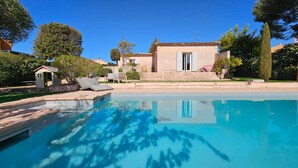 Una piscina amb una casa al fons.
