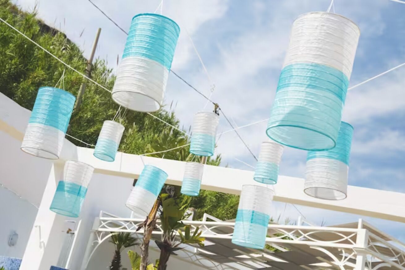 A white structure with hanging cylindrical objects.
