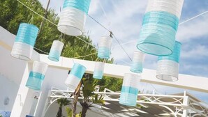 A white structure with hanging cylindrical objects. - Riva Estate Villa by LeDhome (Trappeto)