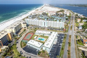 An aerial view of a coastal hotel with a beachside location, multiple buildings, and a parking lot. - Beautiful Ground Floor Venus 119 (Fort Walton Beach)