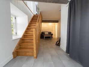 A staircase leading to a living area with a sofa and a coffee table. - 2 Renovated Bedrooms | Historic + Modern Charm in the Heart of Old Quebec (Québec)
