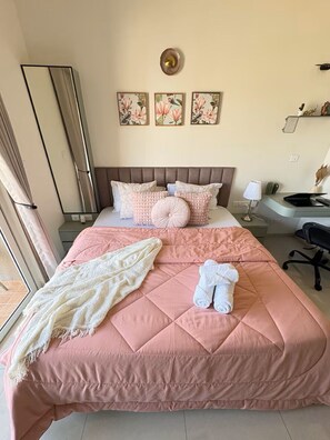 A bedroom with a large bed, a bedside table, a lamp, and a window. - Skyline Haven 2BHK 28th Floor + Pool (Gandhinagar)