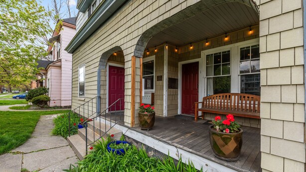 A house with a porch, a wooden bench, and potted plants. - Centrally Located in Brownes Addition (Spokane)