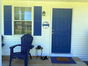 A front door with a sign, a blue chair, a small table, and a doormat. - The Swish & Stay I Cozy 2BR I 15m to RRG I Wi-Fi (Stanton)
