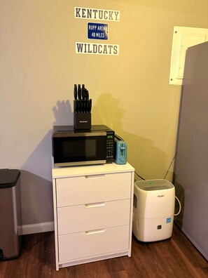 A kitchenette with a microwave, toaster, and a coffee maker on a white cabinet. - The Swish & Stay I Cozy 2BR I 15m to RRG I Wi-Fi (Stanton)