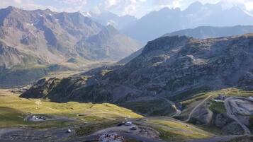A mountainous landscape with winding roads and a clear sky.
