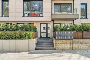 A modern building with a flat facade, large windows, and a small balcony. - 2BR 2Bath Near Kirchberg and Airport (Luxembourg)