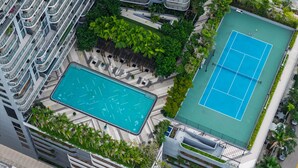 An aerial view of a modern building with a rooftop pool, tennis court, and surrounding greenery. - NEW! Luxury 1 BR Hyde Midtown Walk to Design District and Walk Evreywhere. (Miami)
