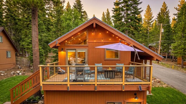 A wooden cabin with a balcony, a deck, and a fire pit. - Tahoe City Escape | Beach Access + Large Deck (Tahoe City)