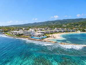 A coastal resort with multiple buildings, a beachfront, and clear blue waters. - Ocean Front Staffed Villa | Lux Resort by Bocobay (St. Ann’s Bay)