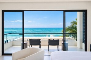 Bedroom 1 opens directly to a private balcony with two chairs and a clear ocean view. - Ocean Front Staffed Villa | Lux Resort by Bocobay (St. Ann’s Bay)