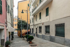 A narrow street with buildings, a staircase, and potted plants. - [Savona Old Town] Cruises 10 mins • Free WIFI (Savona)