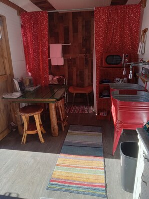A compact kitchen with wooden cabinets, a sink, and a stove.