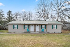A single-story house with a front porch, two green-framed windows, and a metal roof. - Nature's Nook I Cozy 2BR I 15m to RRG I Wi-Fi (Stanton)