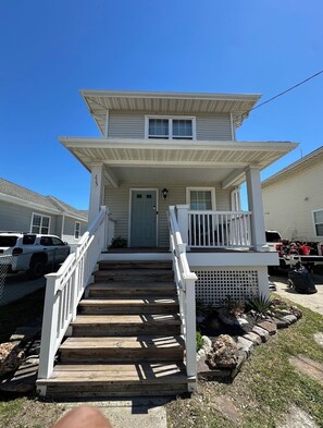 A two-story house with a front porch, wooden steps, and a mailbox. - 3BR 2BA Family-Friendly Beach House in Atlantic City, NJ! (Atlantic City)