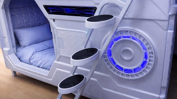 A room with a bed, a control panel, and a circular blue light feature. - Beddy Hostels (Madrid)