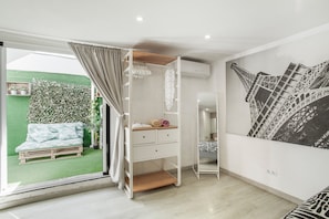 A room with a bed, a desk, a mirror, and a green wall. - Vacation Home 'Ita' with Private Terrace, Wi-Fi and Air Conditioning (Mogán)