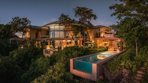 A modern multi-story house with a swimming pool, surrounded by lush greenery. - Bahias No 2 (Nacascolo)