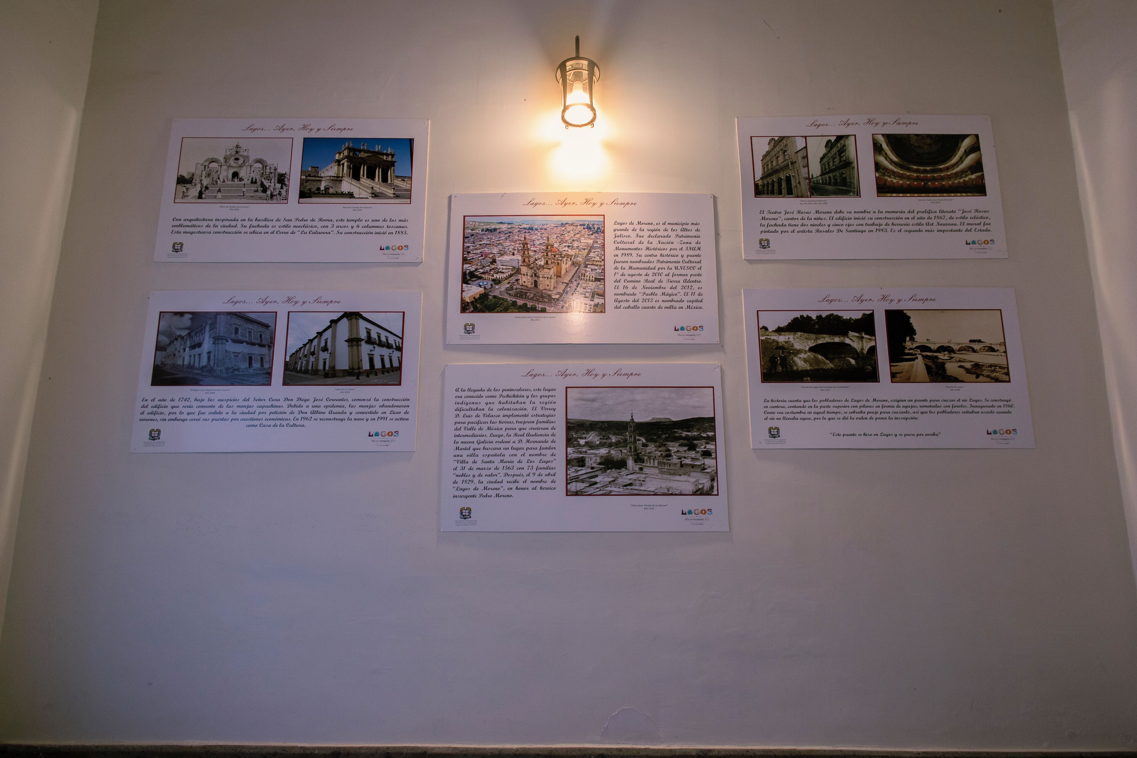 A wall with six informational posters about a location, each with a photo and text.