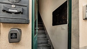 A mailbox, a security device, and a staircase.