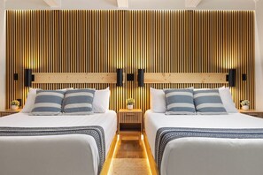 A hotel room with two beds, wooden paneling on the walls, and bedside lamps. - The Sandbar Lodge at Torch Lake (Rapid City)