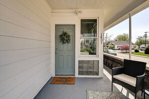A porch with a door, a window, a doormat, and outdoor furniture. - Cute-Downtown Getaway! (Indianapolis)
