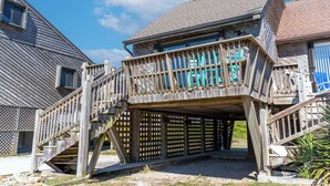 Une structure en bois avec un escalier menant à un espace abrité d’où l’on peut admirer le ciel.