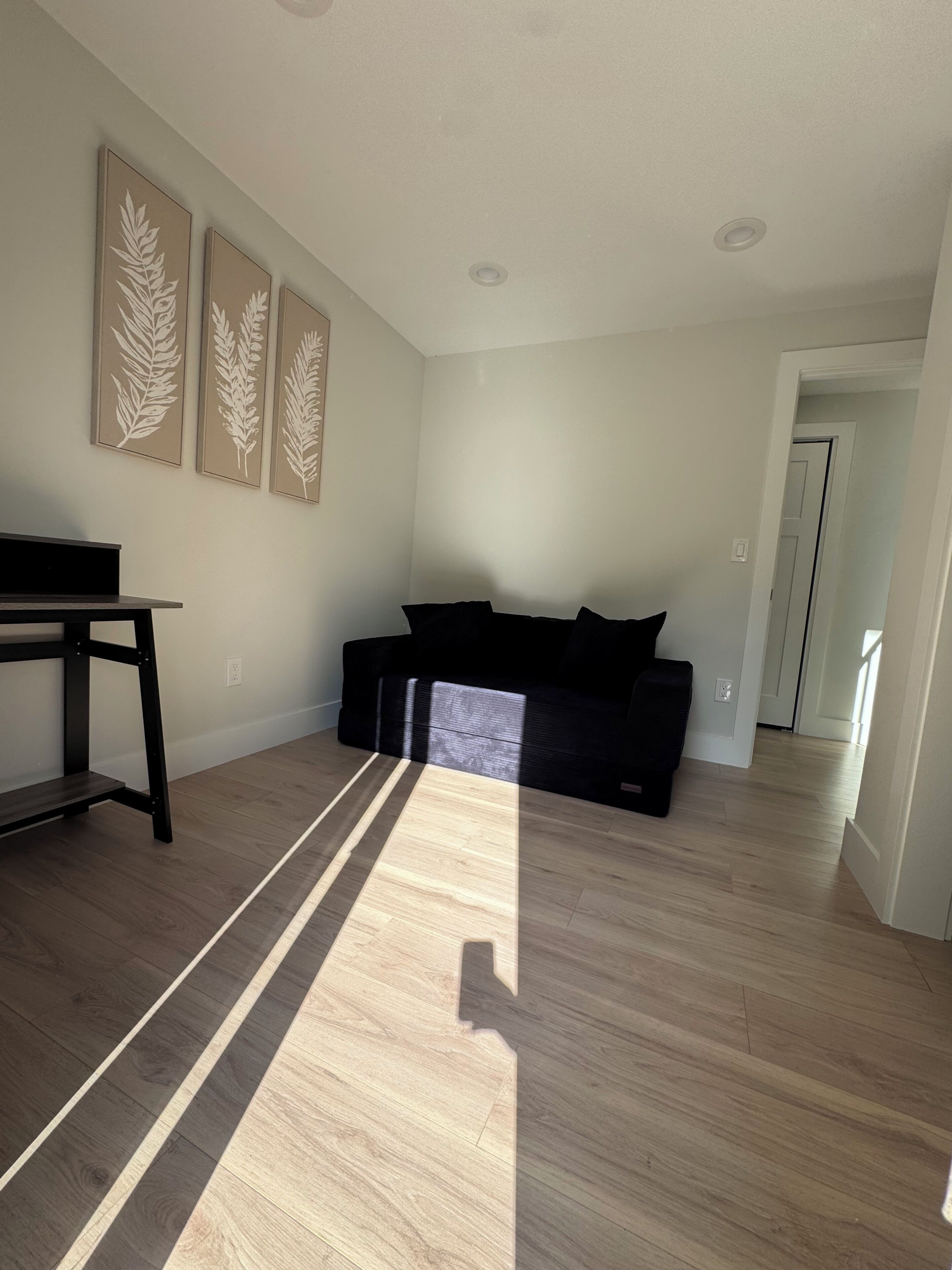 A modern living room with a sectional sofa, a coffee table, and a dining table.