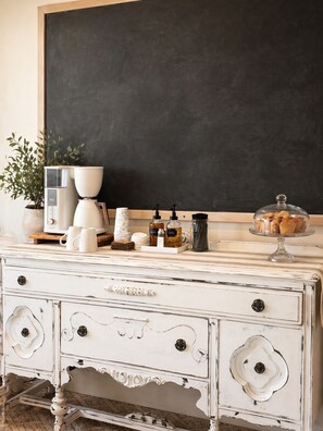 A white dresser with drawers, a coffee maker, a glass jar, and a blackboard on a wooden surface. - Beautiful 1-bedroom bed & breakfast in charming Akron overlooking our Lavender (Akron)