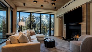 A modern living room with a large TV, fireplace, and a sofa. - Modern Luxury in Downtown Ketchum (Ketchum)