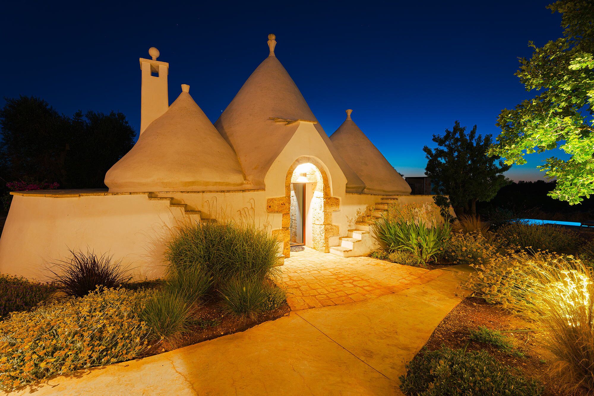 A building with a unique architectural style featuring conical roofs and a central arched entrance.