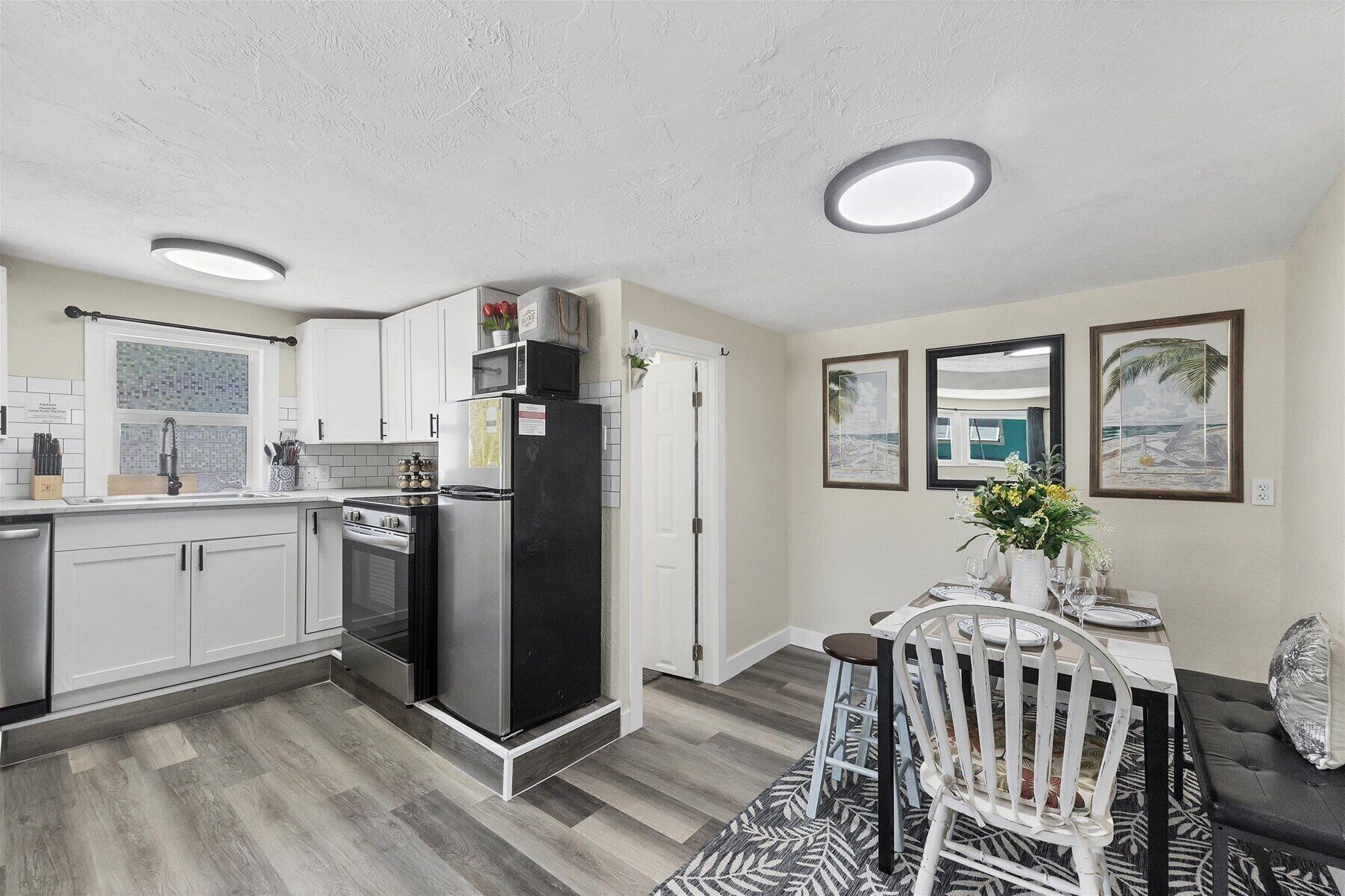Bright kitchen with subway tile, stainless accents & cozy dining nook