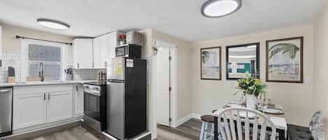 Bright kitchen with subway tile, stainless accents & cozy dining nook