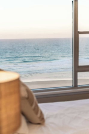 A room with a view of the ocean through a window. - Oceanfront Hamptons 2BR Escape (Surfers Paradise)
