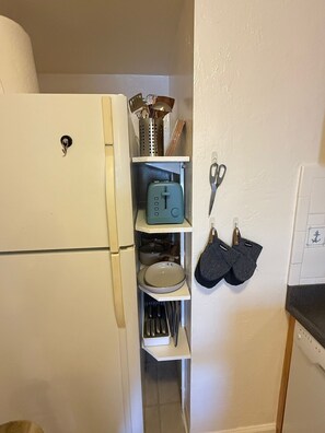 A compact kitchen with a white refrigerator, a toaster, and a knife rack. - Charming 3-bedroom with AC & W/D in Sausalito (Sausalito)