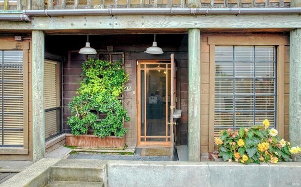 A traditional Japanese-style building with a wooden entrance, a small garden with plants, and a number '46' on the door. - Charming 3-bedroom with AC & W/D in Sausalito (Sausalito)