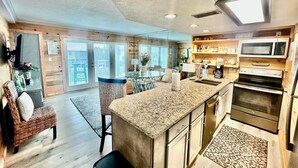 A modern kitchen with granite countertops, stainless steel appliances, and a large island. - Gulfview I 215 (Miramar Beach)