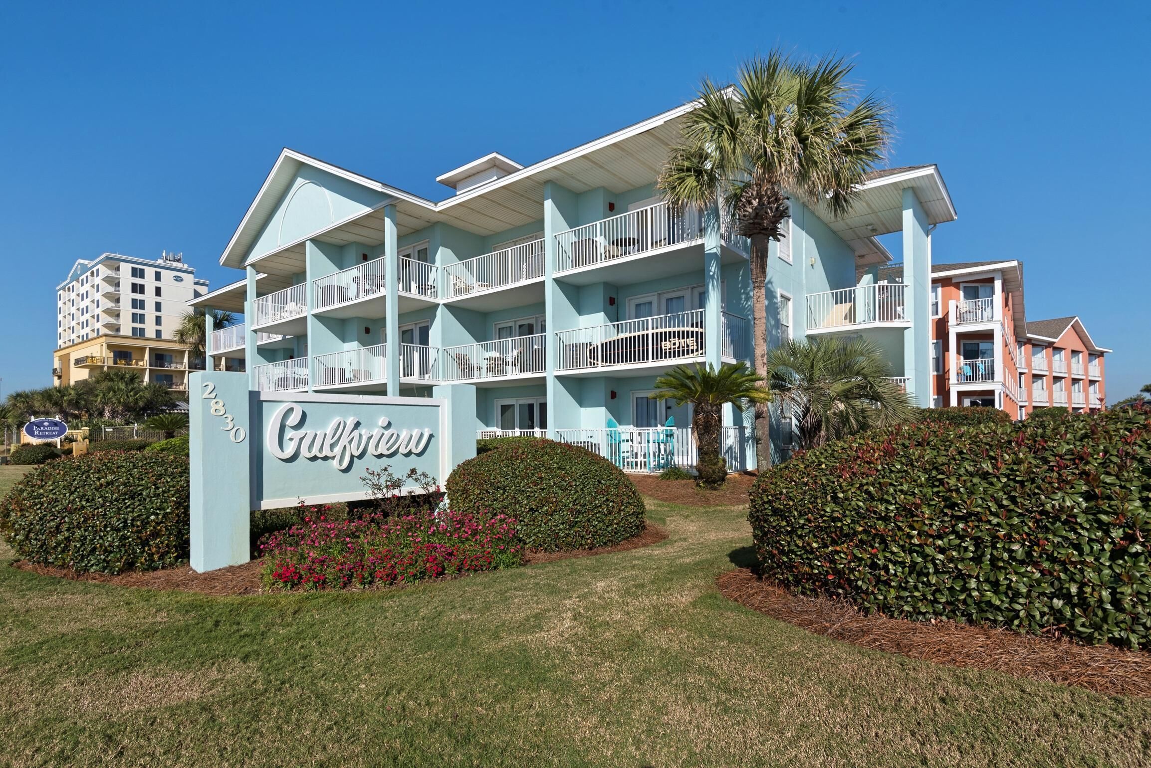 A multi-story hotel with a light blue facade, balconies, and a sign reading 'Gulfview.'