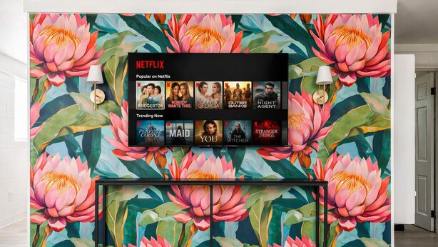 A wall with a Netflix display and a floral mural. - NEW Owner Special King Bed Colorful Quay Themed Duplex Workspace Fuquay-Varina (Fuquay-Varina)