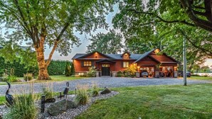 A two-story house with a garage, a driveway, and a well-maintained lawn. - Ô Rivensia | Bord de l`eau | Piscine | SPA (La Vallée-du-Richelieu Regional County Municipality)