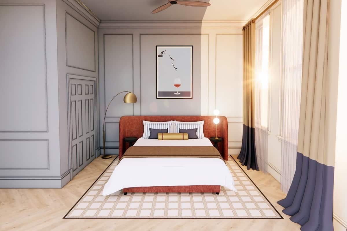 Un dormitorio con cama, ventilador de techo, un cuadro enmarcado y una ventana con cortinas.