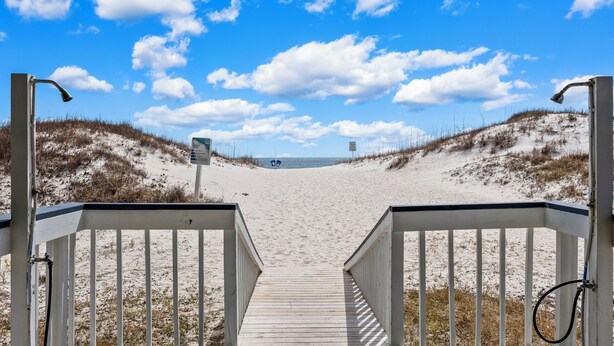 A wooden boardwalk leading to a beach with a clear sky and clouds. - Beautiful beach condo at Regatta Condominiums. 2 BR/2BA, Sleeps up to 6 adults. (Gulf Shores)