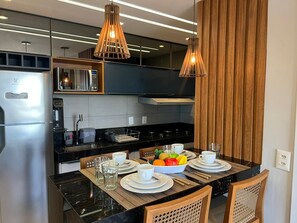 A modern kitchen with a central island, stainless steel appliances, and wooden accents. - Altamare 203 - Luxury and comfort right on the sand at Caribessa beach. (João Pessoa)
