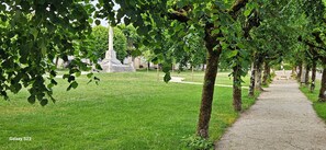A park with a monument, a paved walkway, and trees. - The renovated "Adèlbraz" village house (Voulaines-les-Templiers)
