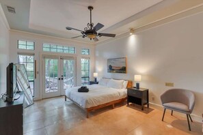 A bedroom with a bed, a chair, a nightstand, a ceiling fan, and a window. - Dallas Gem 5 Bedrooms Home With Pool, Game Room (Dallas)