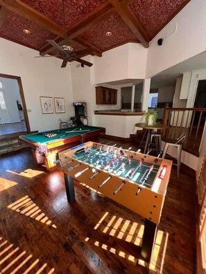A room with a foosball table, a pool table, and a ceiling fan. - Dallas Gem 5 Bedrooms Home With Pool, Game Room (Dallas)
