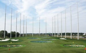 A golf course with multiple holes, flag markers, and tall poles. - 5BR w/ Backyard Paradise, Pool, Cinema, games (North Richland Hills)
