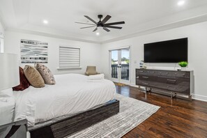 A bedroom with a bed, a ceiling fan, a TV, a dresser, and a window with blinds. - Tropical Pool Paradise x 6-bd, 4-ba Luxury Living (Miami Lakes)